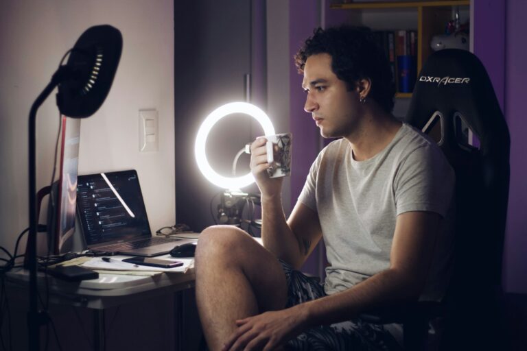 Content creator filming with a ring light at his desk
